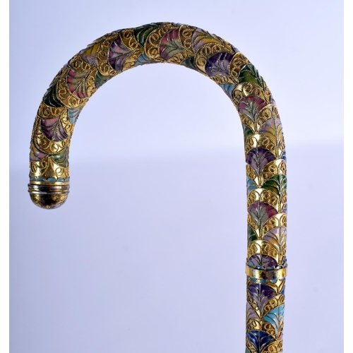 338 - A VINTAGE CONTINENTAL BRASS AND ENAMEL WALKING CANE. 90 cm long.