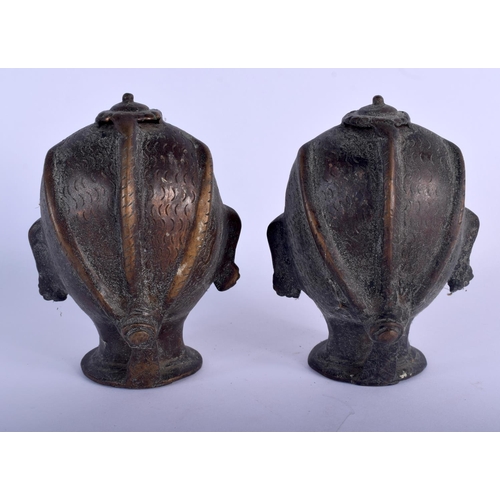 366 - A PAIR OF ANTIQUE INDIAN BRONZE HINDU BUDDHISTIC HEADS. 14 cm high.