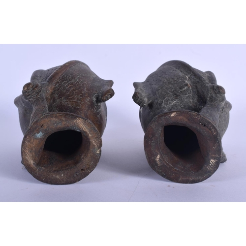 366 - A PAIR OF ANTIQUE INDIAN BRONZE HINDU BUDDHISTIC HEADS. 14 cm high.