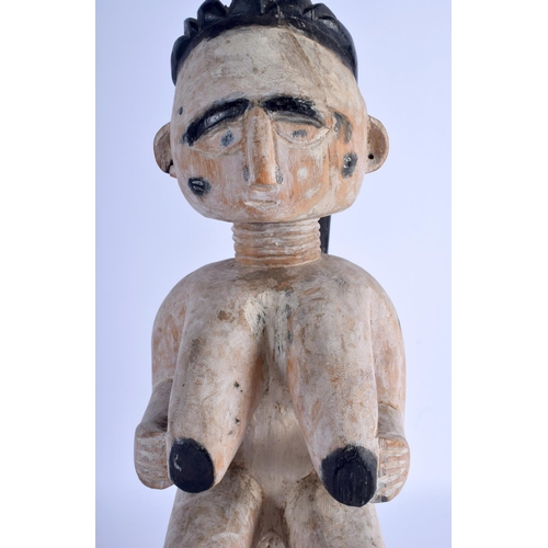 372 - AN AFRICAN WHITE PAINTED TRIBAL CARVED WOOD FIGURE modelled upon a stool. 40 cm high.