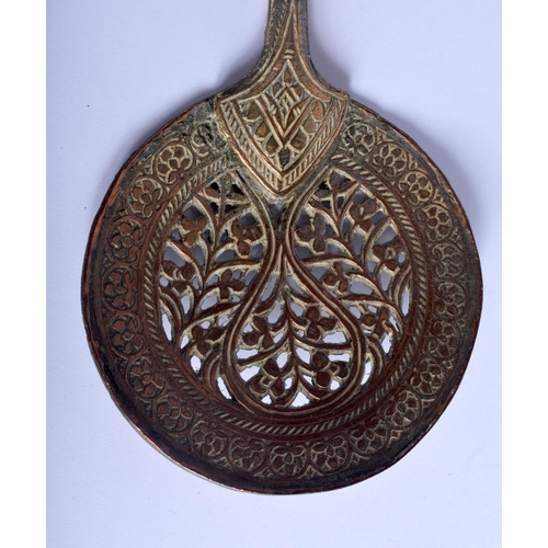 380 - A 19TH CENTURY MIDDLE EASTERN ISLAMIC TYPE HEATING SPOON decorated with foliage. 50 cm long.