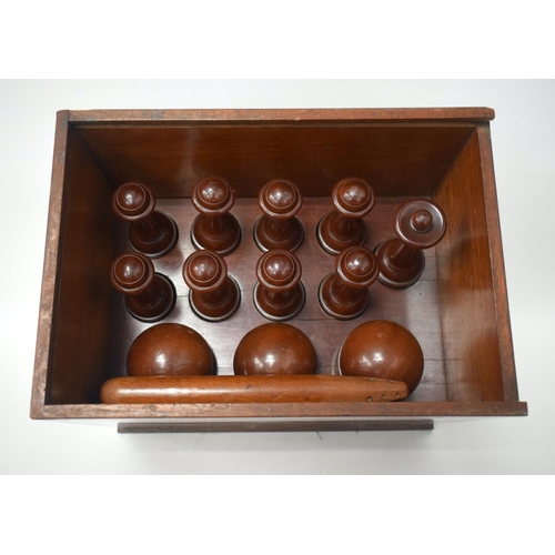 383 - A VERY UNUSUAL LATE VICTORIAN CARVED HARDWOOD SKITTLE SET within original fitted box. 33 cm x 29 cm.