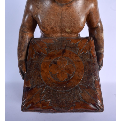 384 - AN 18TH/19TH CENTURY EUROPEAN CARVED WOOD FIGURE OF A KNEELING BOY modelled holding a pillow decorat... 