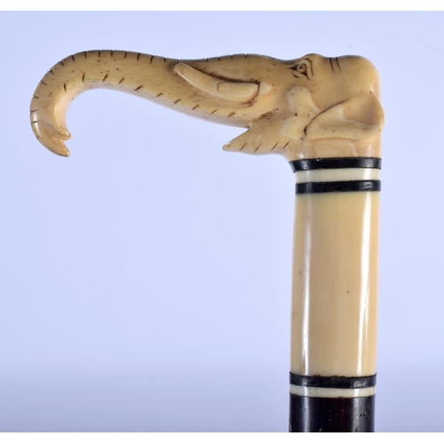 388 - A 19TH CENTURY ANGLO INDIAN CARVED IVORY AND HARDWOOD WALKING CANE formed as an elephant. 90 cm long... 