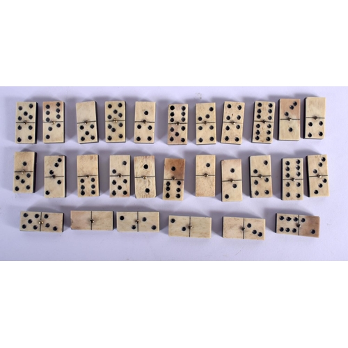 391 - AN ANTIQUE CARVED DOMINO SET together with a bowman tinplate train. Largest 24 cm long. (2)