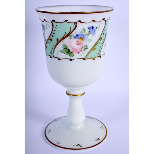 396 - A VINTAGE BOHEMIAN GLASS GOBLET painted with flowers. 18 cm high.