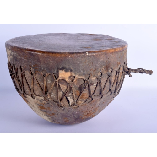 400 - AN EARLY 20TH CENTURY AFRICAN HIDE COVERED ANIMAL SKIN DRUM of naturalstic form. 27 cm x 21 cm.
