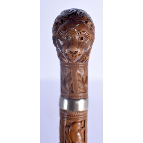 409 - A 19TH CENTURY ANGLO INDIAN CARVED WOOD WALKING CANE with lion head handle, decorated with foliage a... 