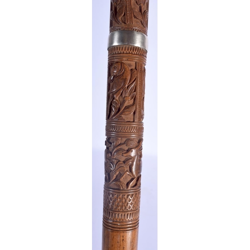 409 - A 19TH CENTURY ANGLO INDIAN CARVED WOOD WALKING CANE with lion head handle, decorated with foliage a... 