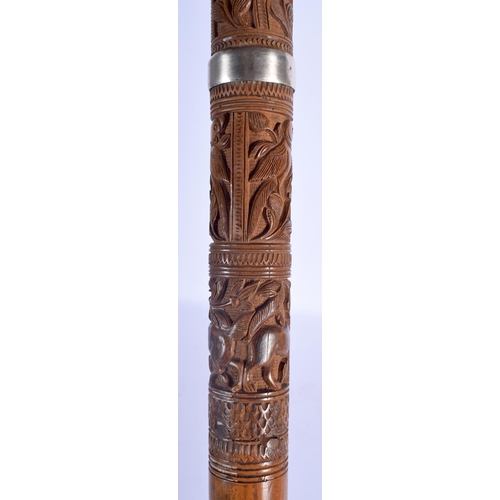 409 - A 19TH CENTURY ANGLO INDIAN CARVED WOOD WALKING CANE with lion head handle, decorated with foliage a... 