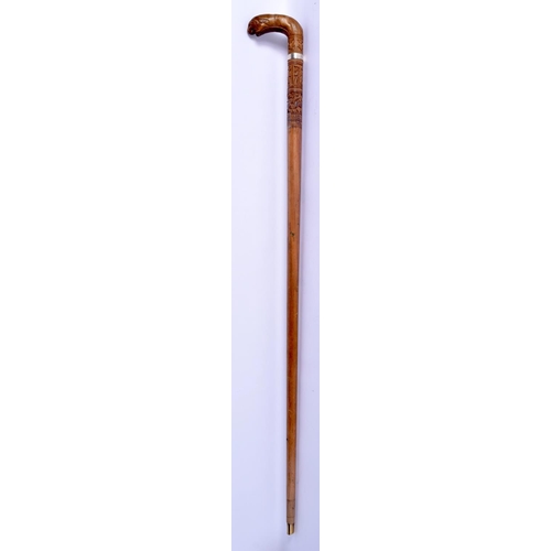 409 - A 19TH CENTURY ANGLO INDIAN CARVED WOOD WALKING CANE with lion head handle, decorated with foliage a... 