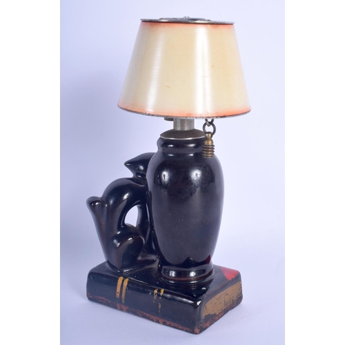 41 - A RARE VINTAGE EVANUS POTTERY CAT TABLE LIGHTER modelled beside a lamp. 14 cm x 7 cm.