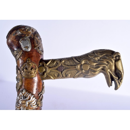 417 - AN UNUSUAL VINTAGE MILITARY FOLK ART TYPE EAGLE HEAD WALKING CANE of almost cermonial axe head form.... 