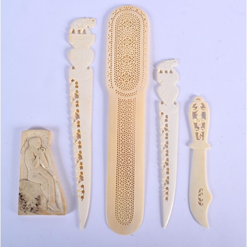 426 - A 19TH CENTURY ANGLO INDIAN CARVED IVORY LETTER OPENER together with similar wares. Largest 24 cm lo... 