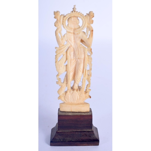 428 - A 19TH CENTURY ANGLO INDIAN CARVED IVORY FIGURE OF A BUDDHISTIC DEITY modelled upon a carved wood ba... 