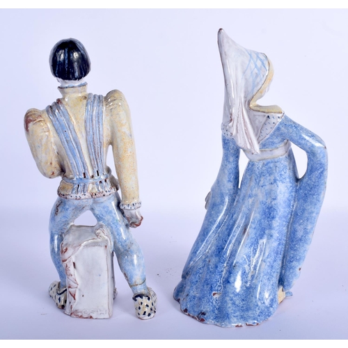 43 - A PAIR OF CONTINENTAL FAIENCE GLAZED POTTERY FIGURES modelled as theatrical characters. 22 cm high.