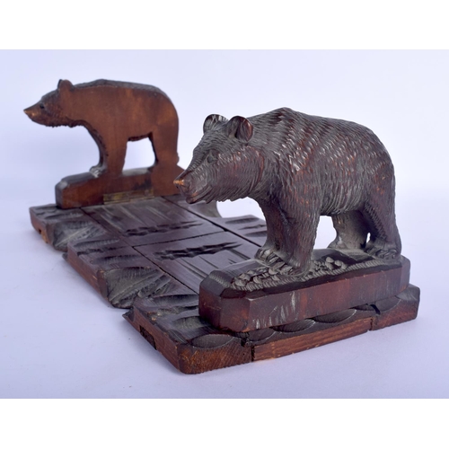 431 - AN EARLY 20TH CENTURY BAVARIAN BLACK FOREST SLIDING BOOK RACK formed as standing bears. 44 cm x 12 c... 