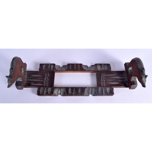 431 - AN EARLY 20TH CENTURY BAVARIAN BLACK FOREST SLIDING BOOK RACK formed as standing bears. 44 cm x 12 c... 