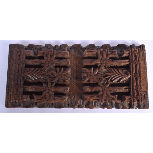 437 - A 19TH CENTURY BAVARIAN BLACK FOREST SLIDING WOOD BOOK RACK formed with foliage and gate posts. 46 c... 