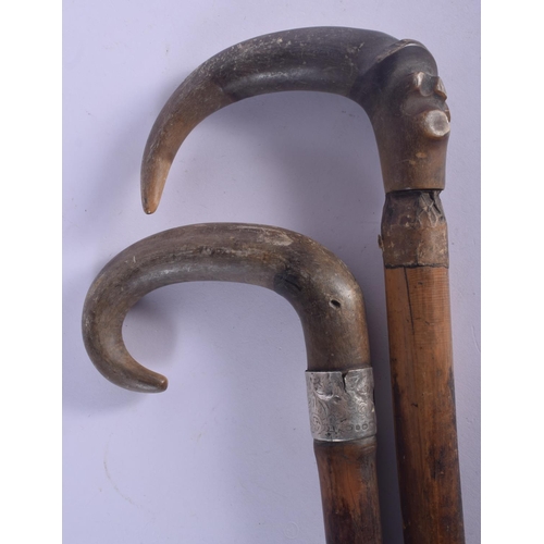 444 - TWO 19TH CENTURY MIDDLE EASTERN CARVED RHINOCEROS HORN WALKING CANES one with silver banding. 83 cm ... 