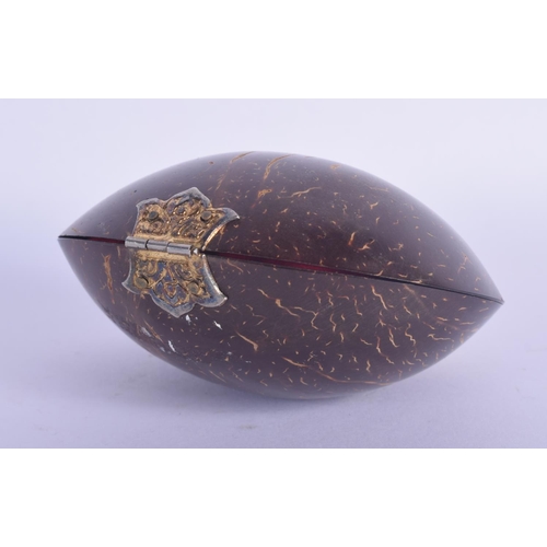 445 - AN ANTIQUE TRIBAL CARVED COCONUT SHELL PURSE with yellow and white metal mounts. 10 cm x 7 cm.