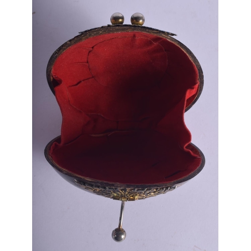445 - AN ANTIQUE TRIBAL CARVED COCONUT SHELL PURSE with yellow and white metal mounts. 10 cm x 7 cm.