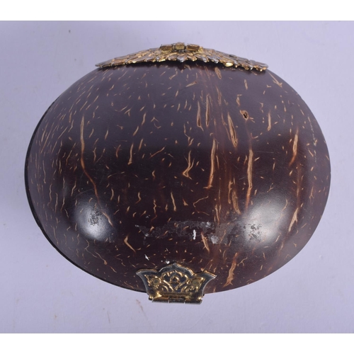 445 - AN ANTIQUE TRIBAL CARVED COCONUT SHELL PURSE with yellow and white metal mounts. 10 cm x 7 cm.