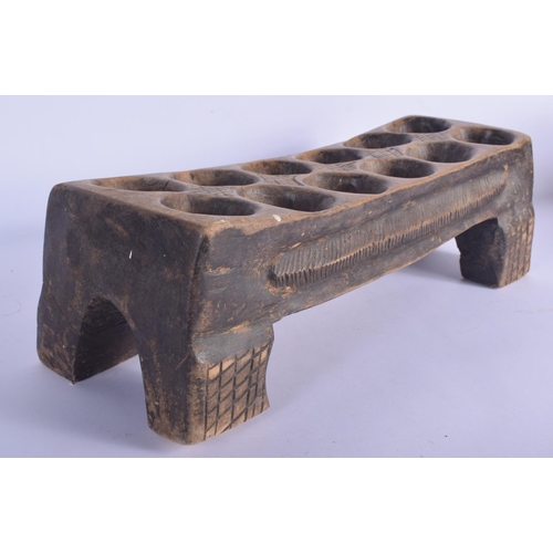 454 - AN UNUSUAL VINTAGE TRIBAL CARVED WOOD MANCALA GAMING BOARD with carved nut counters. Board 50 cm x 1... 