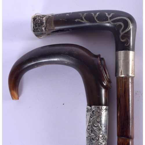 469 - TWO 19TH CENTURY CONTINENTAL CARVED RHINOCEROS HORN HANDLED WALKING CANES one with silver mounts. 90... 