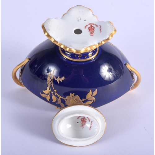 52 - A ROYAL CROWN DERBY TWIN HANDLED VASE AND COVER enamelled with gilded flowers. 13 cm x 12 cm.