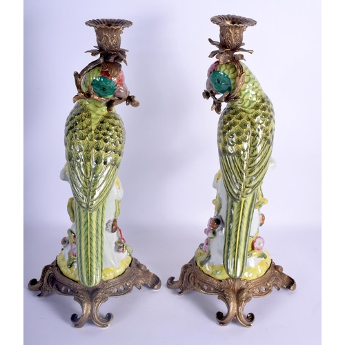 73 - A LARGE PAIR OF CONTEMPORARY PARROT GILT METAL CANDLESTICKS. 36 cm high.