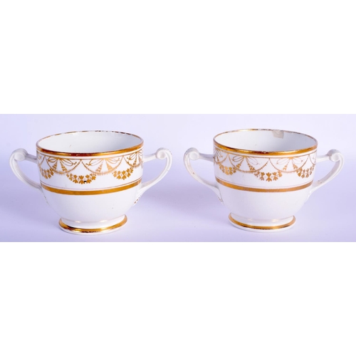 8 - A PAIR OF EARLY 19TH CENTURY TWIN HANDLED GILDED CUPS AND SAUCERS Coalport or Derby, painted with ne... 