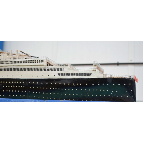 433 - A VERY LARGE MID 20TH CENTURY PAINTED SCRATCH BUILT MODEL BOAT OF THE QUEEN MARY modelled upon a pai... 