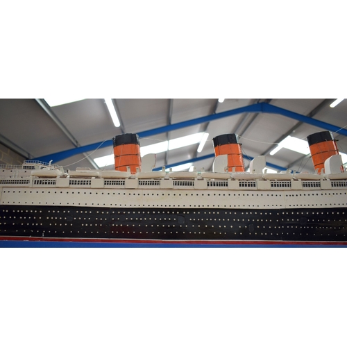 433 - A VERY LARGE MID 20TH CENTURY PAINTED SCRATCH BUILT MODEL BOAT OF THE QUEEN MARY modelled upon a pai... 