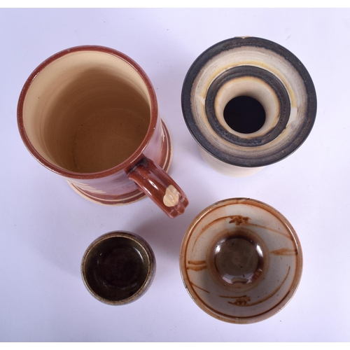 101 - A SLIP DECORATED HOKANA TREACLE GLAZED TANKARD together with three other studio pottery vessels. Lar... 