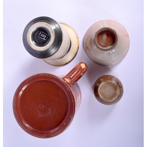 101 - A SLIP DECORATED HOKANA TREACLE GLAZED TANKARD together with three other studio pottery vessels. Lar... 