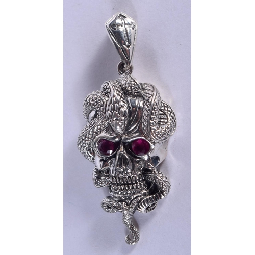 1011 - A SILVER AND RUBY SKULL PENDANT. 13 grams. 5.5 cm x 2.5 cm.