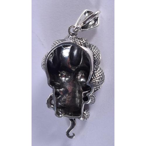 1011 - A SILVER AND RUBY SKULL PENDANT. 13 grams. 5.5 cm x 2.5 cm.