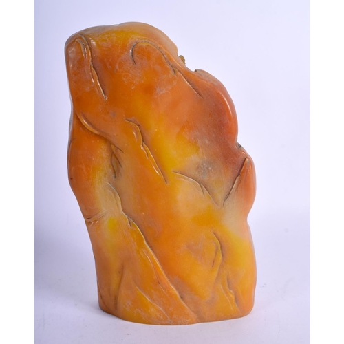 1024 - A CHINESE CARVED ORANGE SOAPSTONE MOUNTAIN. 22 cm x 12 cm.