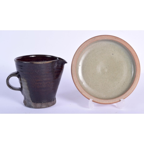 104 - A ST IVES STUDIO POTTERY JUG and a St Ives plate. Largest 14 cm wide. (2)