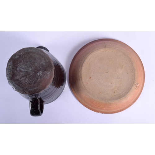 104 - A ST IVES STUDIO POTTERY JUG and a St Ives plate. Largest 14 cm wide. (2)