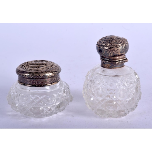 1050 - A SILVER TOPPED SCENT BOTTLES TOGETHER WITH A JAR AND COVER.  Hallmarked Birmingham 1901 and 1902, S... 