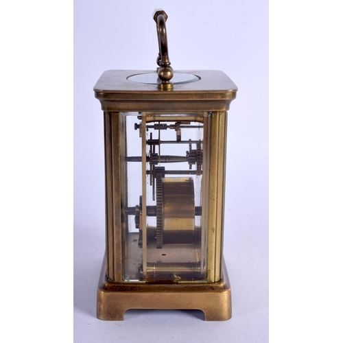 1082 - A BRASS CARRIAGE CLOCK.  10.8cm high (13.8cm with handle raised) x 7.9cm x 6.3cm with key