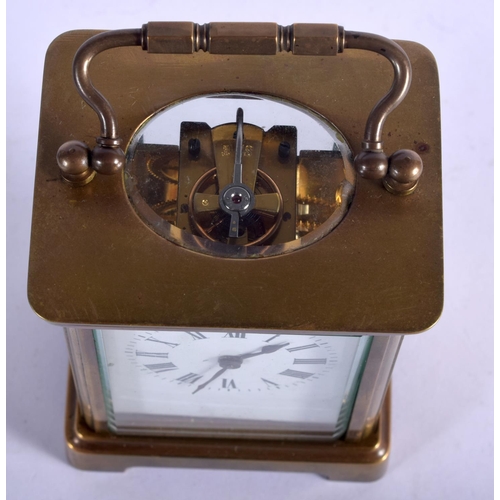 1082 - A BRASS CARRIAGE CLOCK.  10.8cm high (13.8cm with handle raised) x 7.9cm x 6.3cm with key