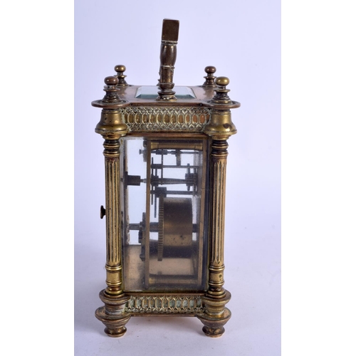 1083 - A BRASS CARRIAGE CLOCK.  13.5cm high (16.1cm with handle raised) x 8.5cm x 7cm with key