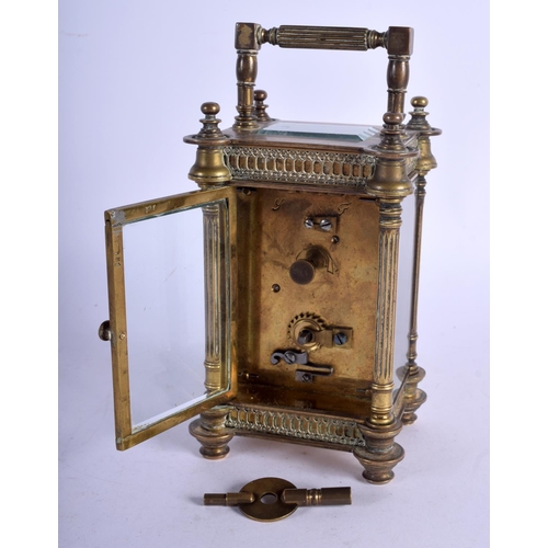 1083 - A BRASS CARRIAGE CLOCK.  13.5cm high (16.1cm with handle raised) x 8.5cm x 7cm with key