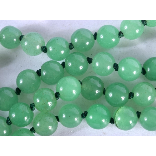 1095 - A JADE NECKLACE.  Length 68cm, bead size 7.8mm, weight 58g