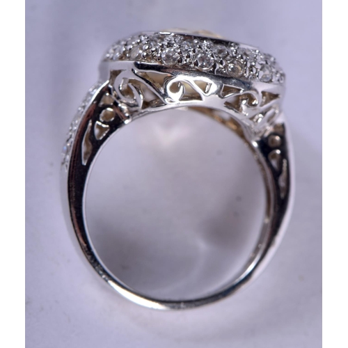 1099 - A SILVER CROSSOVER RING INSET WITH A CZ STONE.  Size N, weight 6g