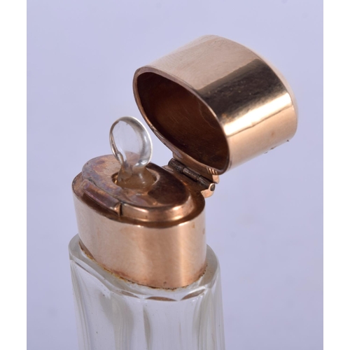 1145 - A GOLD TOPPED SCENT BOTTLE.  12.3cm x 4cm, weight 53.6g