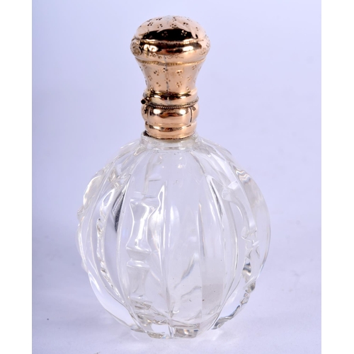 1147 - A GOLD TOPPED SCENT BOTTLE.  7.5cm x 4.4cm, weight 66.4g